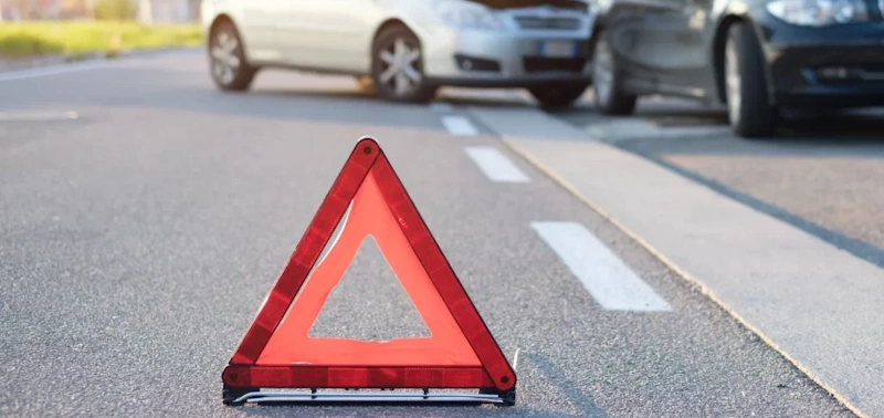 Reflective red triangle on the road at a car crash scene