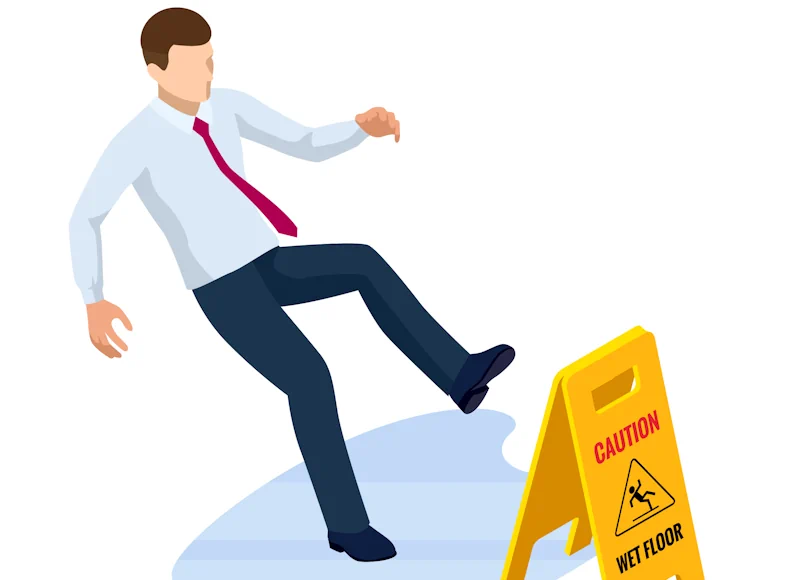 a man having a slip on a wet floor next to a warning sign