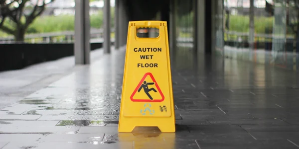 A caution sign on a wet floor used to prevent slip and fall accidents