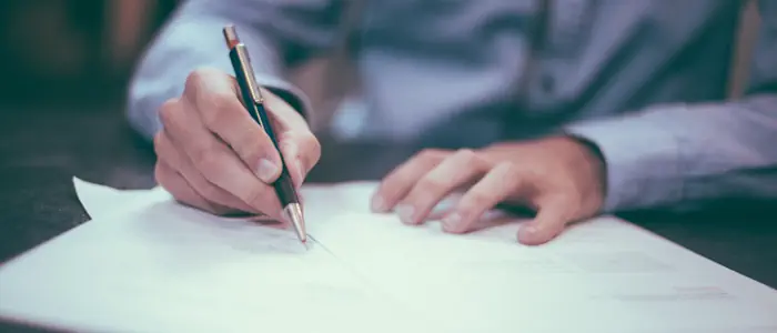 Close-up image of a person completing a TPD claim form